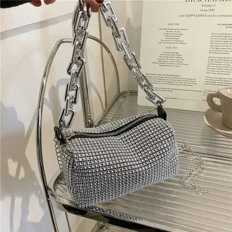 Silver allover rhinestone bucket bag with glitter chain strap, perfect for a stylish prom or versatile occasion.