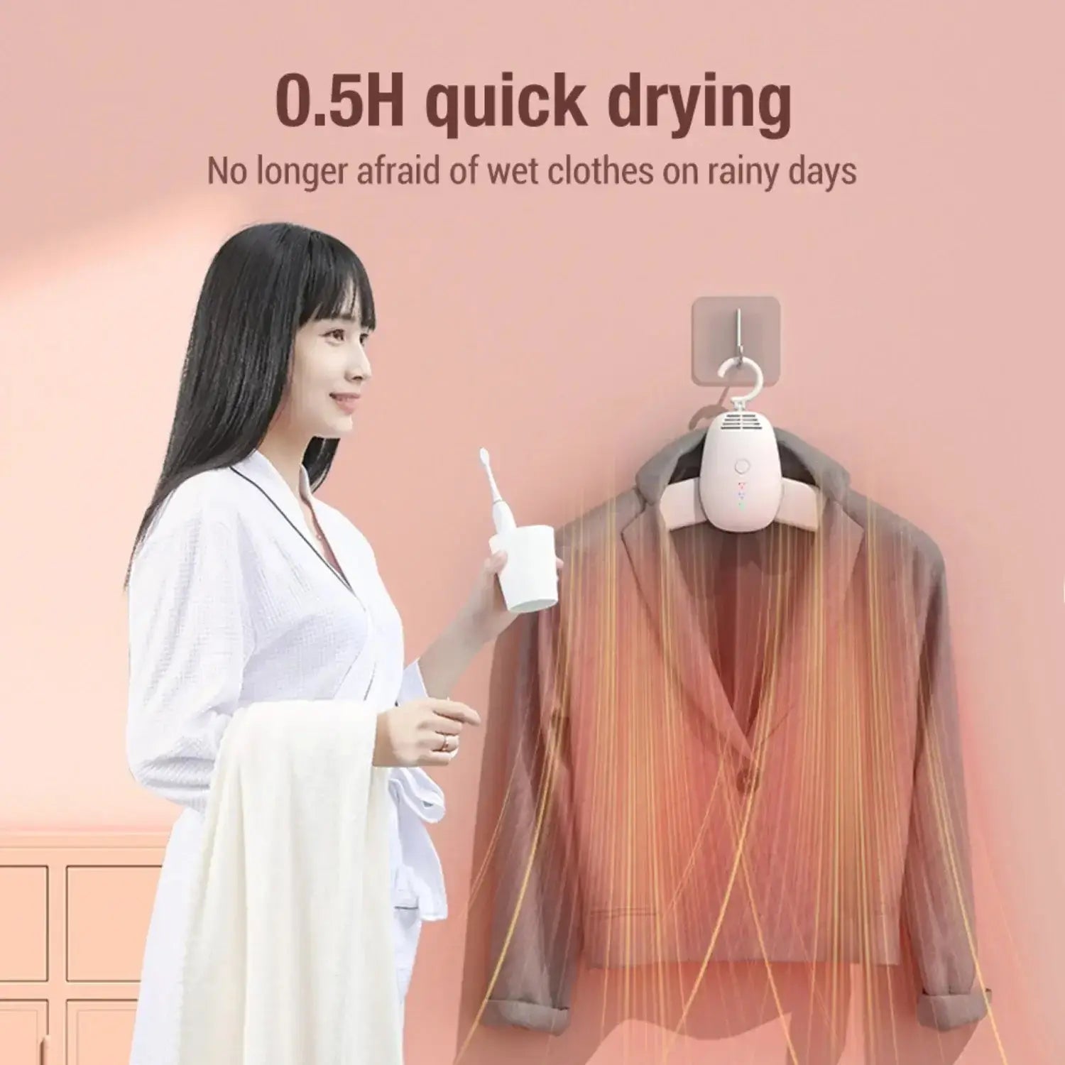 Woman using portable clothes dryer with quick drying feature, demonstrating ease of drying clothes in damp weather.