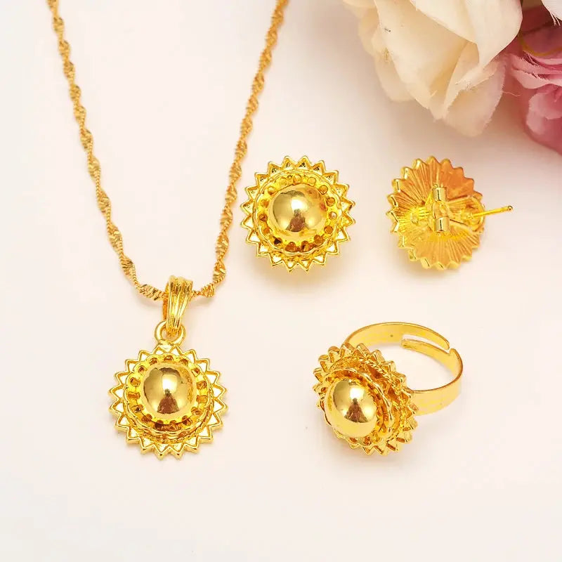Gold color Ethiopian jewelry set including necklace, earrings, and ring, styled for a bride or festive occasion.