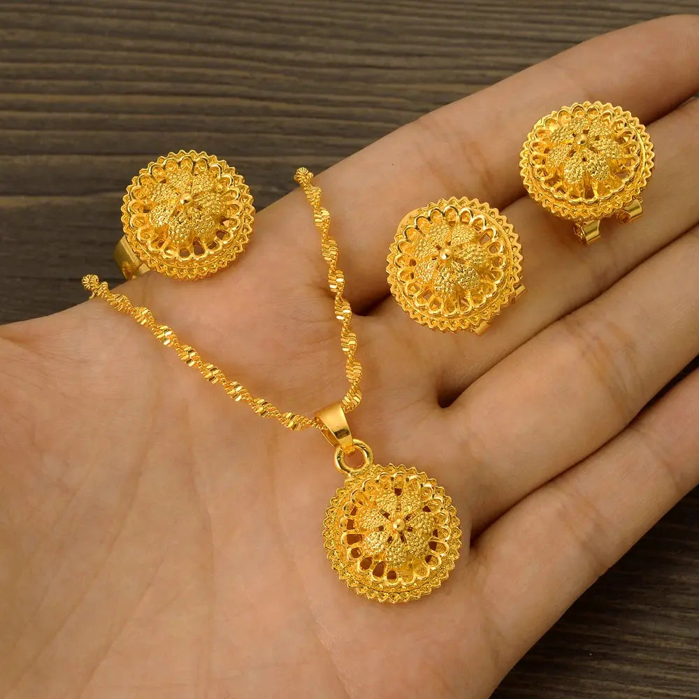 Gold color Ethiopian jewelry set including necklace, earrings, and ring, styled for a bride or festive occasion.