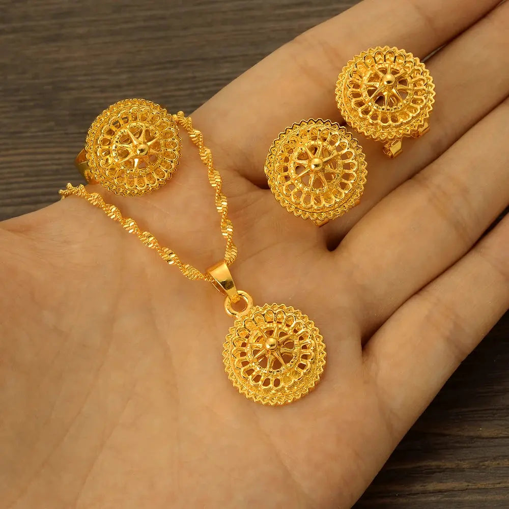 Gold color Ethiopian jewelry set including necklace, earrings, and ring, styled for a bride or festive occasion.