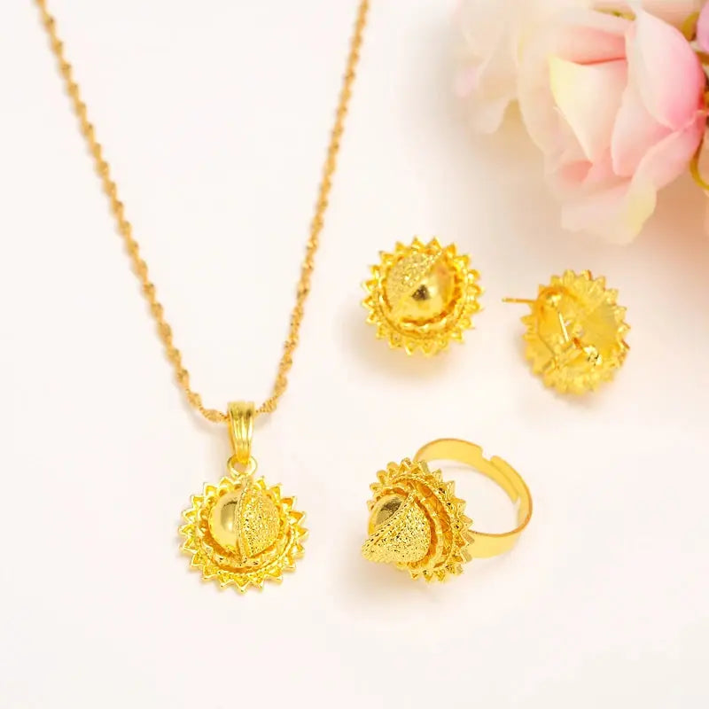 Gold color Ethiopian jewelry set including necklace, earrings, and ring, styled for a bride or festive occasion.