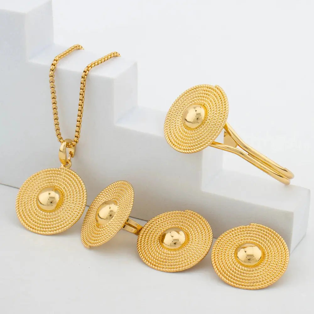 Gold-tone African-style jewelry set with necklace, earrings, bangle, and ring for weddings or parties.