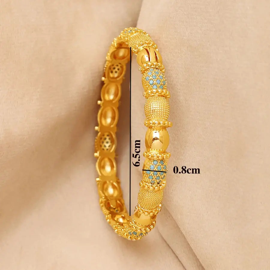 Set of four openable copper bracelets with Middle Eastern design worn on a woman’s wrist.