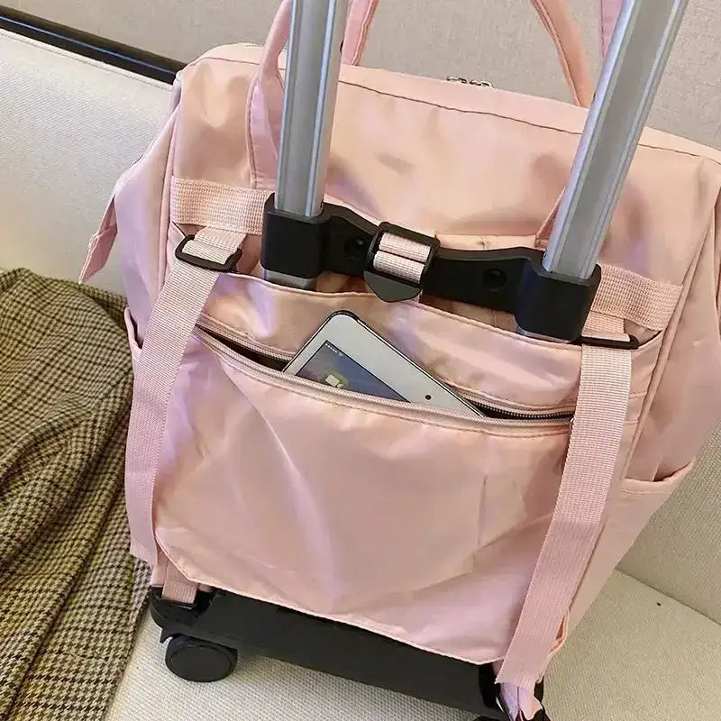 Stylish pink portable travel bag with handle and wheels, featuring a front pocket for easy access to essentials.