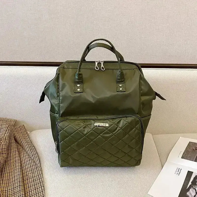 Stylish dark green designer bag with quilted detail, perfect for travel or daily use.