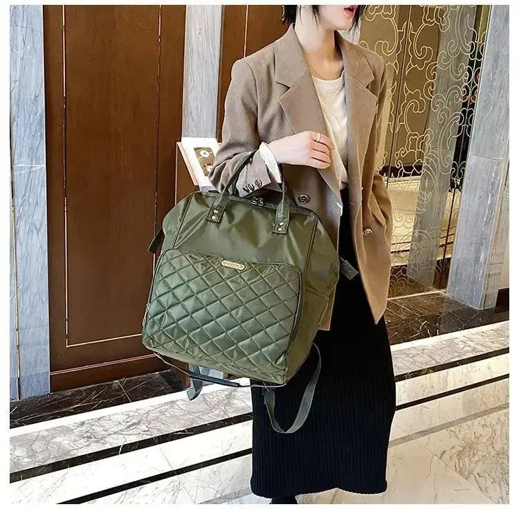 Stylish green quilted portable travel bag carried by a woman in a chic outfit, perfect for travel.