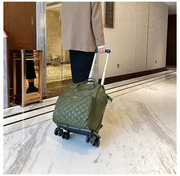 Stylish large capacity portable travel bag in olive green being wheeled through a modern lobby.