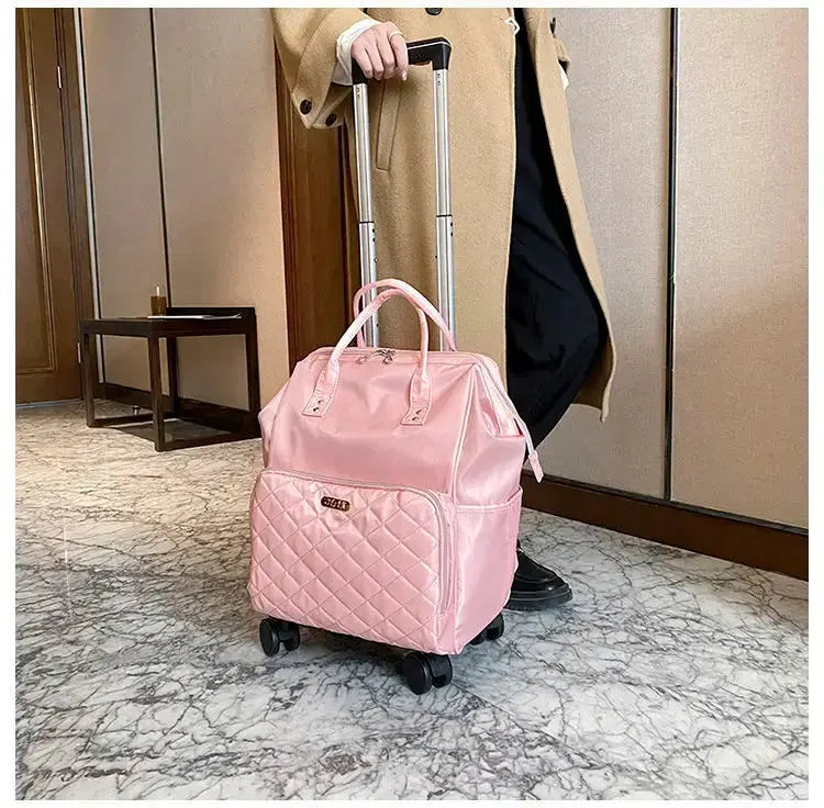 Stylish pink portable travel bag on wheels, perfect for women, in a modern interior setting.