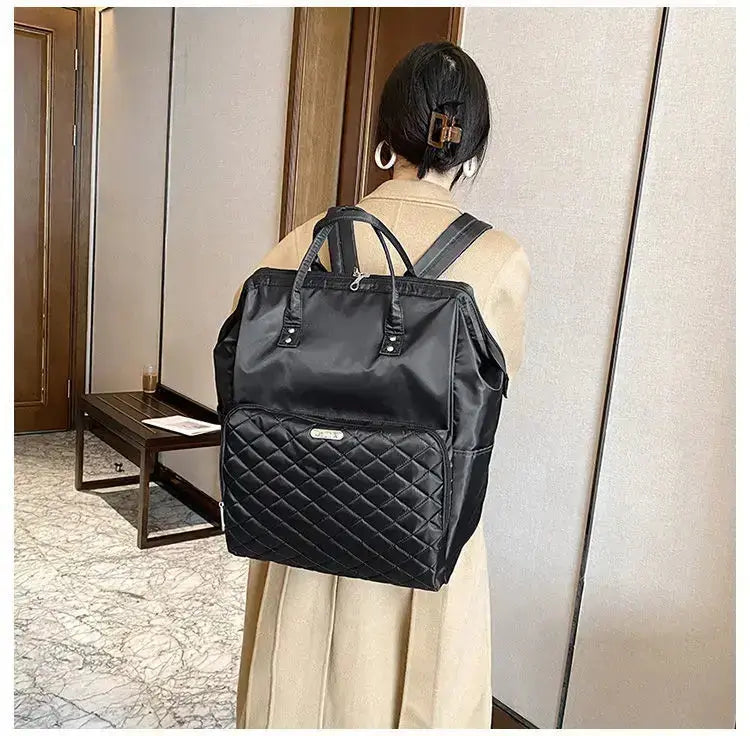 Stylish black designer backpack with quilted details, perfect for travel and daily use.