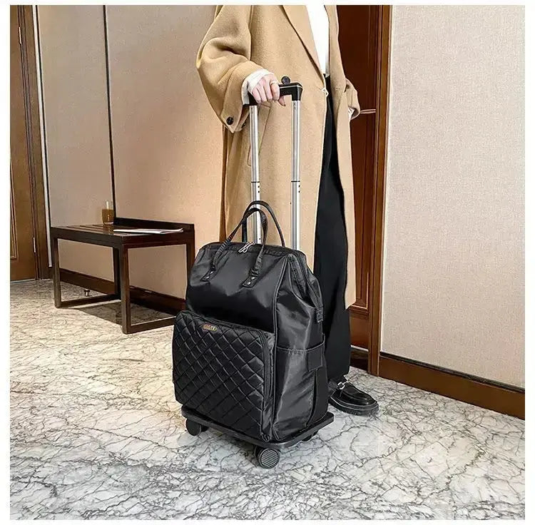 Stylish black portable travel bag on wheels, perfect for women, featured in modern indoor setting.