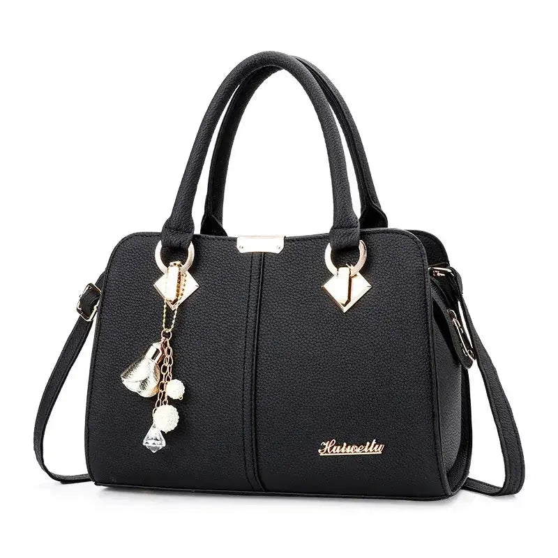 Black handbag for women with gold accents and decorative charms, stylish and versatile design.
