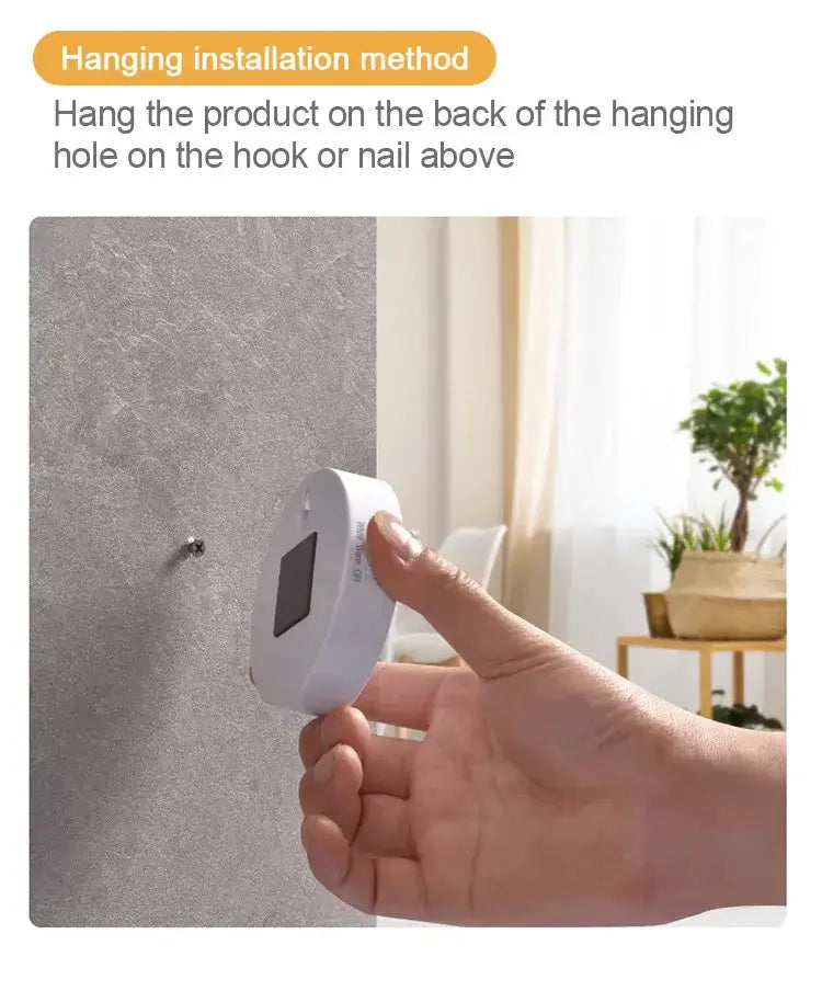 Person installing a LED night light with a hanging method on a wall hook.