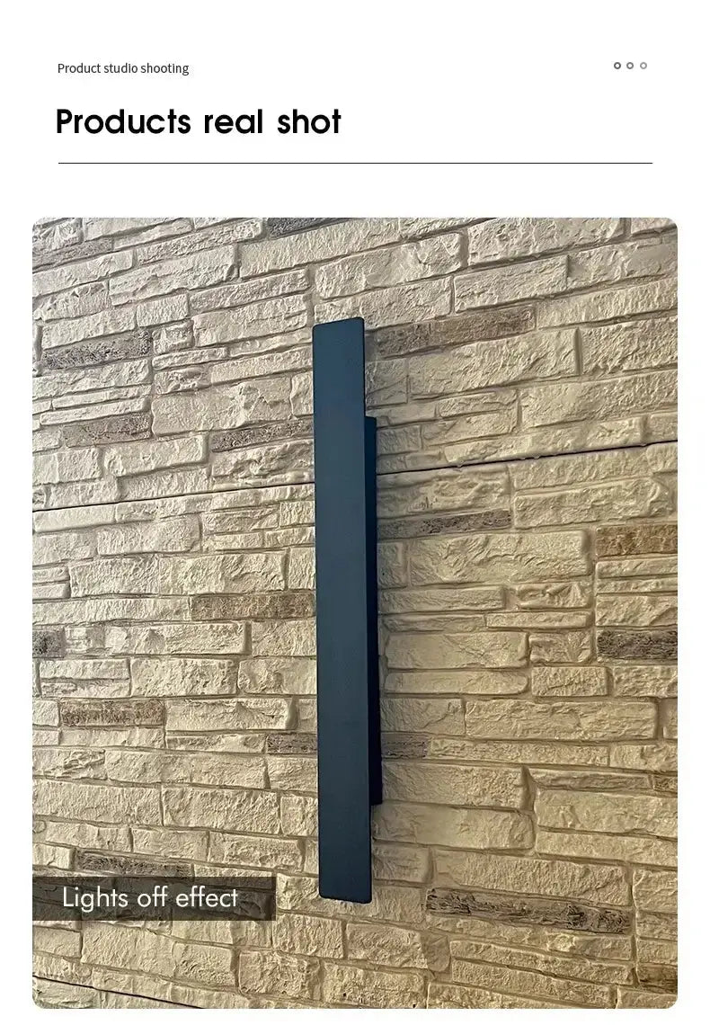 Applique murale extérieure noire en aluminium sur mur en pierre, effet lumière éteinte.