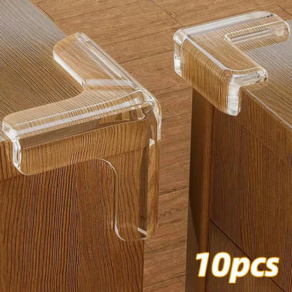 Transparent silicone baby safety corner guards on a wooden table to prevent child injury.

