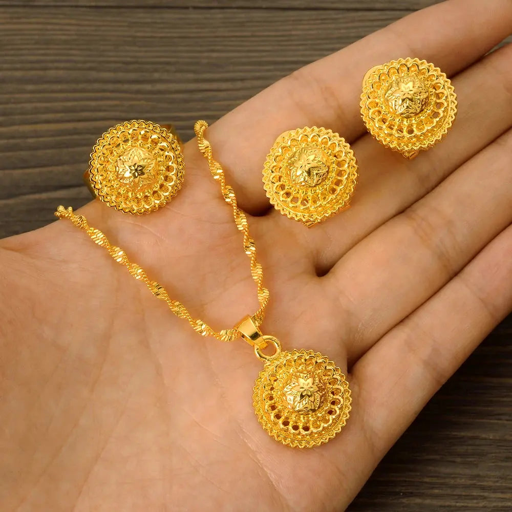 Gold color Ethiopian jewelry set including necklace, earrings, and ring, styled for a bride or festive occasion.