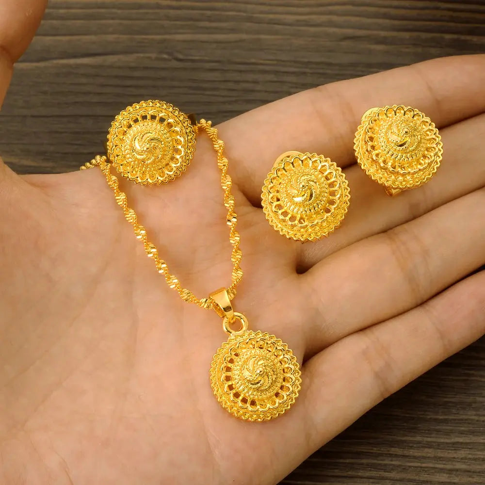 Gold color Ethiopian jewelry set including necklace, earrings, and ring, styled for a bride or festive occasion.