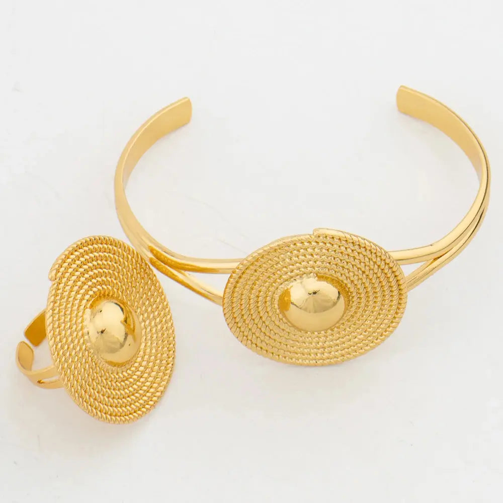 Gold-tone African-style jewelry set with necklace, earrings, bangle, and ring for weddings or parties.