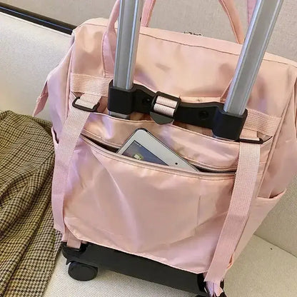 Stylish pink portable travel bag with handle and wheels, featuring a front pocket for easy access to essentials.