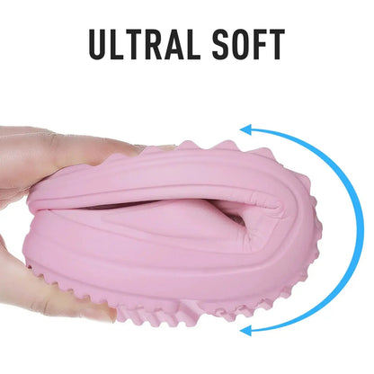 Main image of ultra-soft pink EVA sandal being squeezed in hand, highlighting flexibility and comfort.