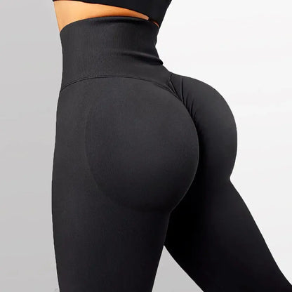 High-waisted seamless knitted leggings worn by a woman during a fitness workout, showing a peach-lift design and nude color finish.