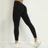 Woman wearing high-waisted scrunch butt gym leggings in Lycra material during a fitness pose.